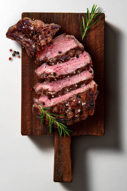 istock Sliced flavored rib eye beef on dark wooden cutting board 2150022047