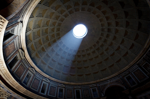 Rome, Italy. June 26, 2021. Low angle view of light beam falling through oculus of ancient Pantheon's dome in Rome, Italy