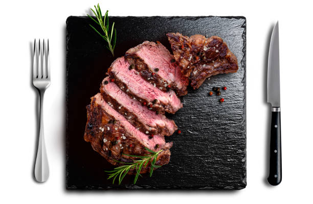 istock Rib eye beef sliced on black flavored stone with fork knife 2150022257