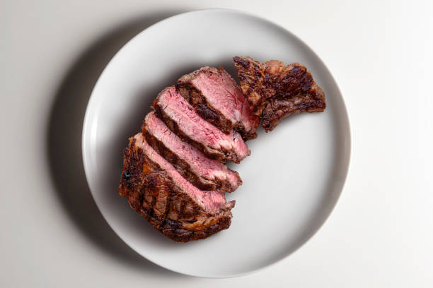 istock Rib eye beef sliced on round white 2150022431