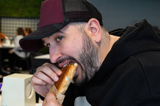 istock A man eating toast with an appetite. 2150024585