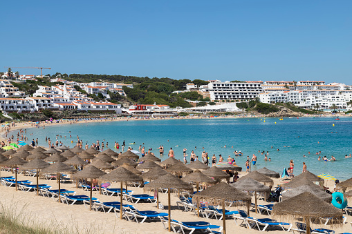 Arenal d'en Castell, Spain, June 25, 2023; People enjoy the beach at the seaside resort of Arenal d'en Castell on the island of Menorca.