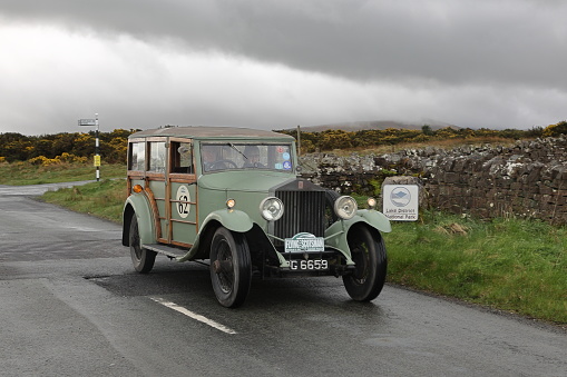 Caldbeck, England - April 13:  A 1929 Rolls Royce 20-25 leaves Caldbeck, Cumbria on April 13, 2024.  The car is taking part in the Flying Scotsman Rally, a free public-event.