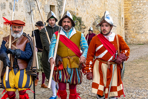 Torrelobatón, Valladolid-Spain, April 23, 2024; Theatrical representation of Roman soldiers in an open-air medieval market, Men and Women dressed as Romans in a Medieval village.