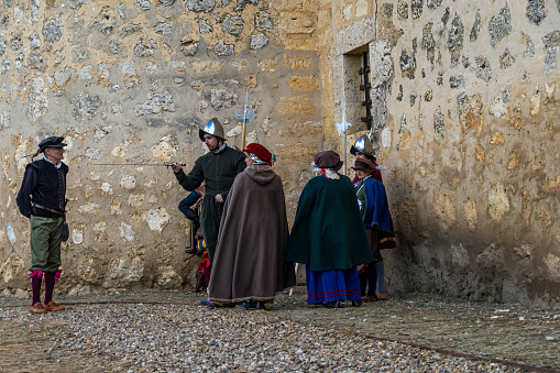 Torrelobatón, Valladolid-Spain, April 23, 2024; Theatrical representation of Roman soldiers in an open-air medieval market, Men and Women dressed as Romans in a Medieval village.