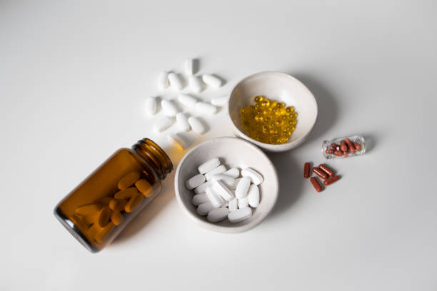 istock Many different pills and capsules on white background 2150027161