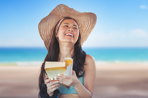 Cheerful woman smiling at camera on the beach resort during summer vacation