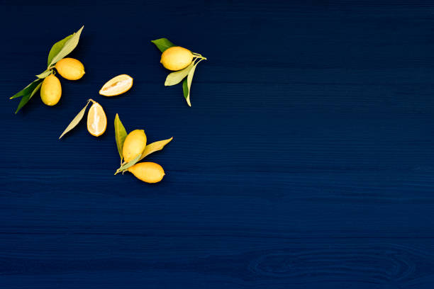 Fresh Lemons with Leaves  on Dark Blue Wooden Background