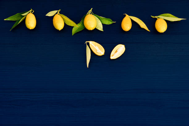 Fresh Lemons with Leaves  on Dark Blue Wooden Background