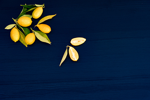 Fresh Lemons with Leaves  on Dark Blue Wooden Background