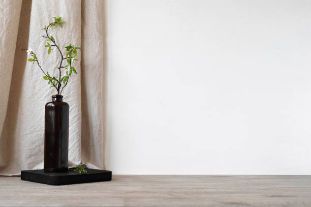istock Aesthetic sustainable home interior decor, empty table top, white wall with copy space, beige linen curtain, brown vase with green tree branch. Podium backdrop for branding product placement template 2150033553