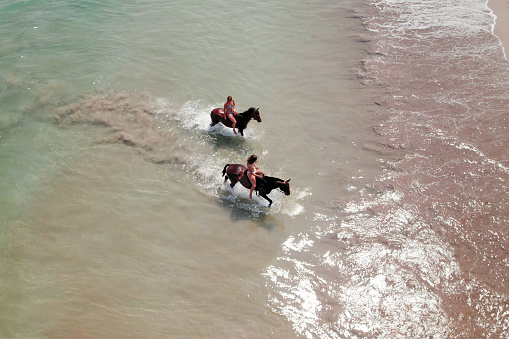 Riding Horses in the Water