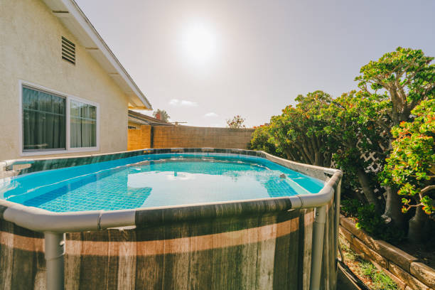 istock Above-ground pool in a backyard surrounded by greenery. 2150038717