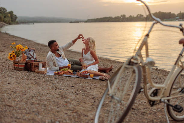 istock Beautiful couple having a picnic date by the river 2150039747
