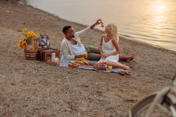 istock Beautiful couple having a picnic date by the river 2150039774