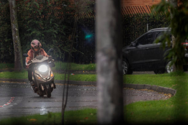 Bogota, Colombia., 18 de Abril de 2024:Driving a motorcycle in the rain on the road