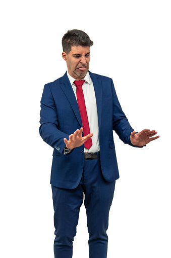 vertical businessman he extends his hands forward and downward in rejection gesture, while displaying a contradictory facial expression. he embodies corporate rejection and confusion white background