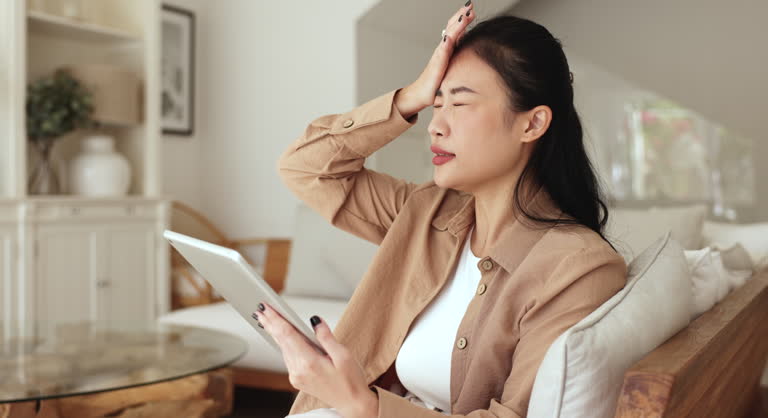 Woman use tablet looks stressed, dissatisfied by battery draining quickly