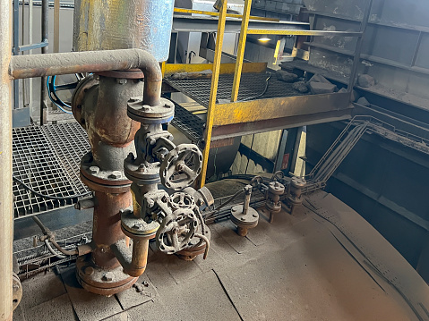 Valves and other safety equipment on an old steam boiler. Extensive wear, corrosion and contamination of the equipment and the boiler.