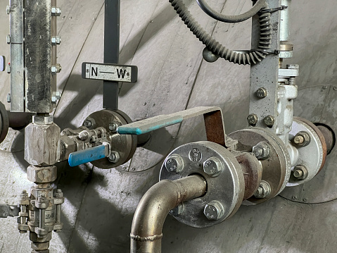 Valves, level indicator and other fittings at a small steam boiler.