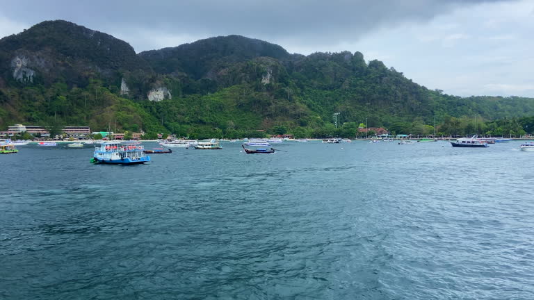Lot of boats anchored in Phi Phi at daytime, Tonsai pier