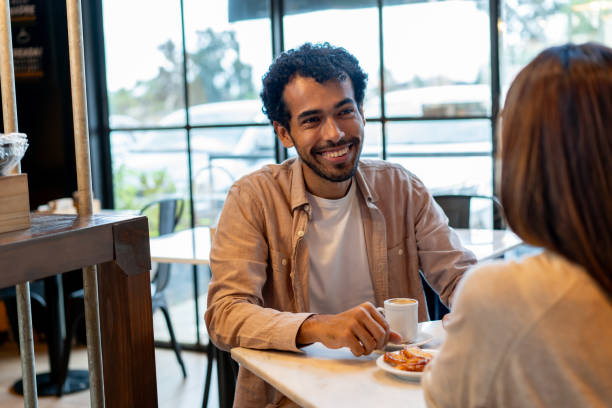 istock Happy friends meeting at a cafe and talking 2150044409