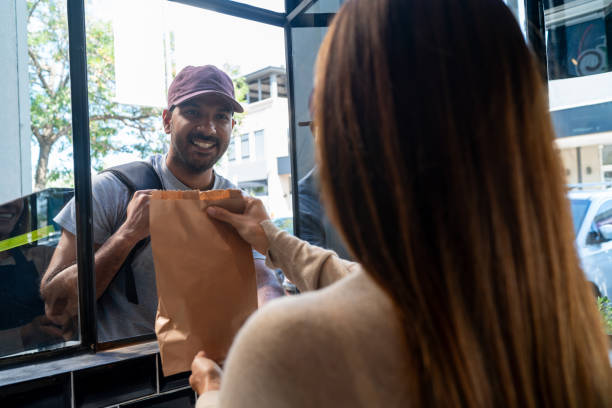 istock Delivery person picking up an order at the bakery 2150044416
