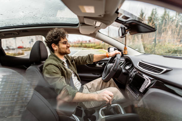 Young businessman driving a car