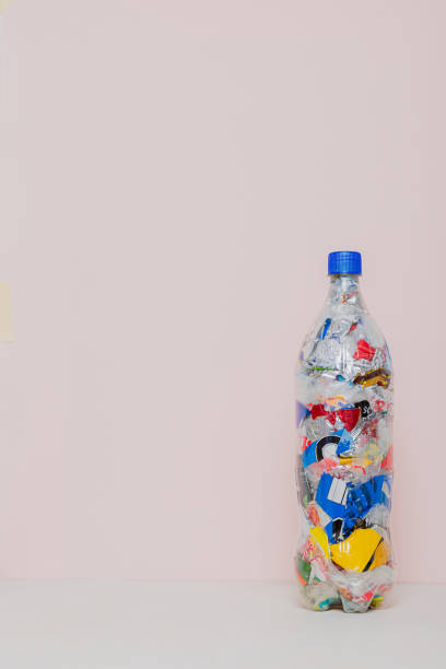 istock isolated eco brick PET bottle stuffed with plastic waste 2150049959