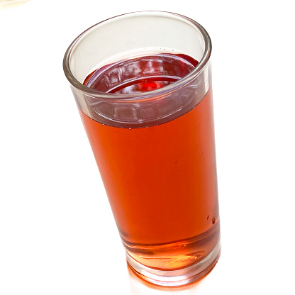 View of an isolated glass with tea over white background