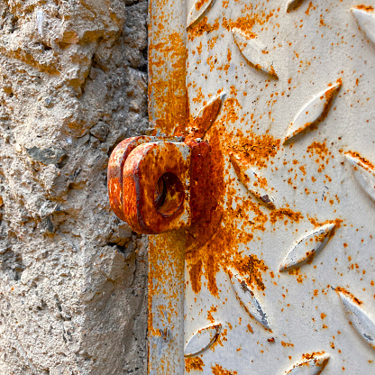 Close up view of rusty metal door without padlock