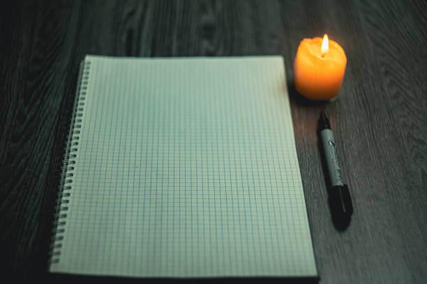 istock Large notebook and black marker in candlelight 2150052160