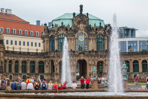 The gardens with fountains and the facade of one of the buildings of the Zwinger palace in Dresden, Germany