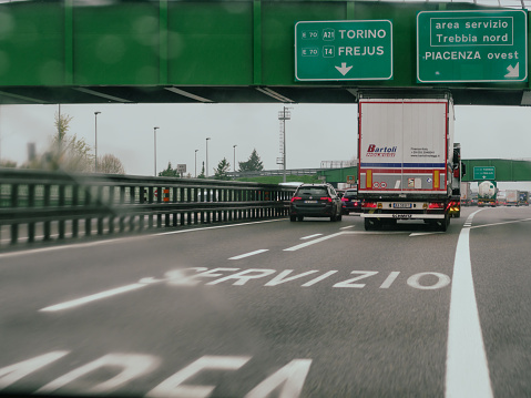 Milan, Italy - April 26th 2023 on the road on a highway under cloudy conditions, A1 A8 highway near Milan, Italy