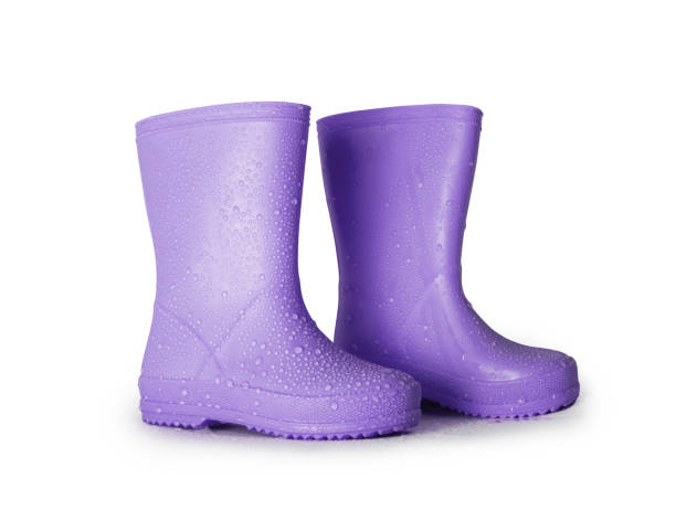 istock Stylish purple rubber boots with raindrops on the surface isolated on a white background 2150057521