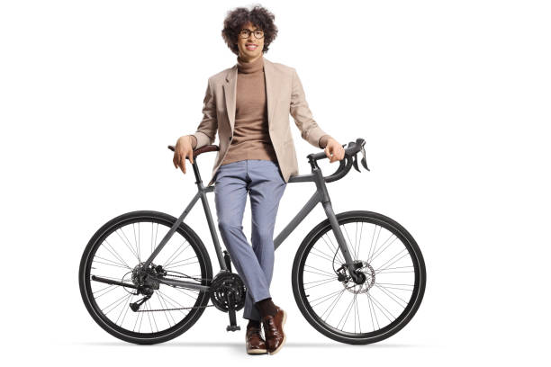 istock Young man sitting on a bicycle and looking at camera 2150057848