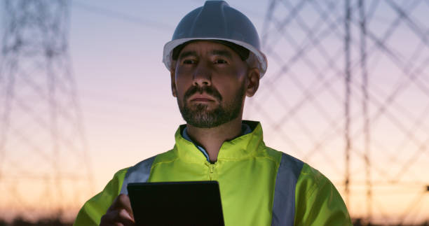 istock Power grid, online and man with tablet for electricity, circuit and voltage infrastructure at night. Engineering, energy and technician on digital tech for inspection with wires, cable or maintenance 2150058274