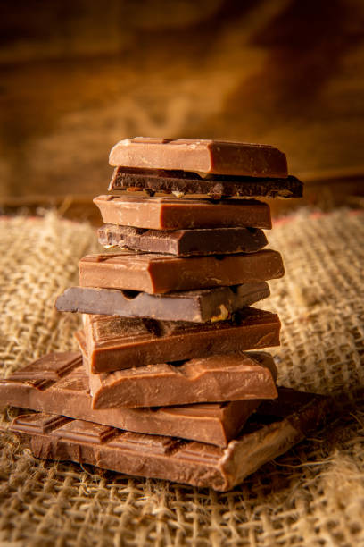 istock Vertical photo of a stack of chocolate pieces on a rustic background 2150058580