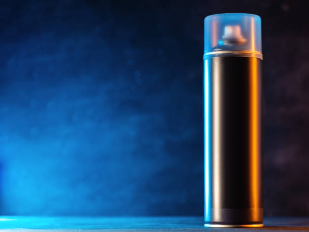istock Aerosol enclosed can with paint or varnish on a blue background, copy space 2150058586
