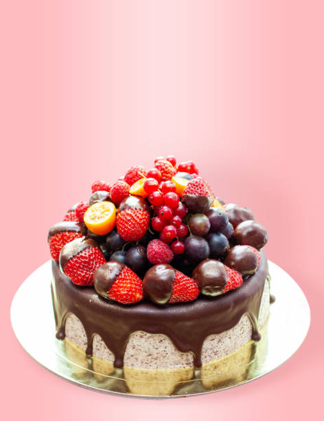 istock Cake decorated with strawberry dipped into melted chocolate, raspberry, blueberry and red currant. Isolated on plain background 2150058608