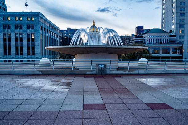 Sunset Over The Dome of the State Capitol of Wisconsin and a fountain as viewed from Monona Terrace