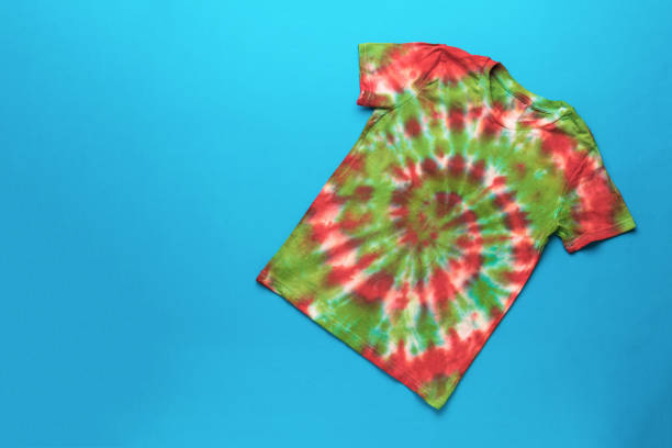 istock A red and green tie dye T-shirt on a blue background. 2150065563