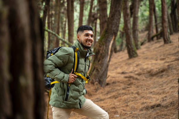 istock Young man exploring in the forest surrounded by trees and nature 2150068288