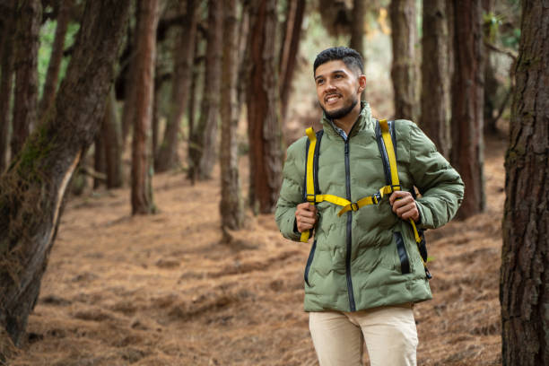 istock Young man exploring in the forest surrounded by trees and nature 2150068313