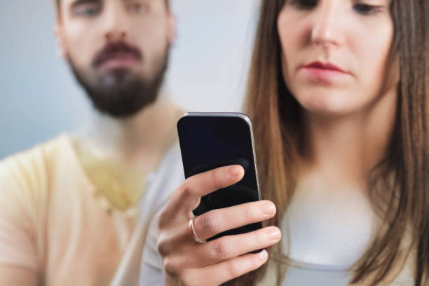 istock Mistrust in his eyes; she's digitally absorbed 2150068347