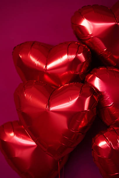 istock Balloons red hearts on a burgundy background. 2150071253