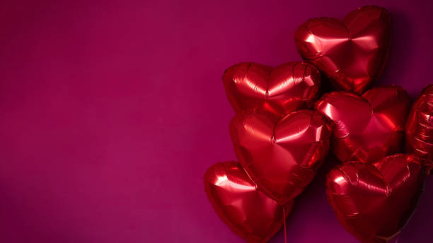 istock Balloons red hearts on a burgundy background. 2150071255