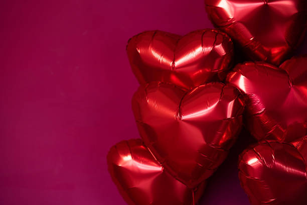 istock Balloons red hearts on a burgundy background. 2150071261