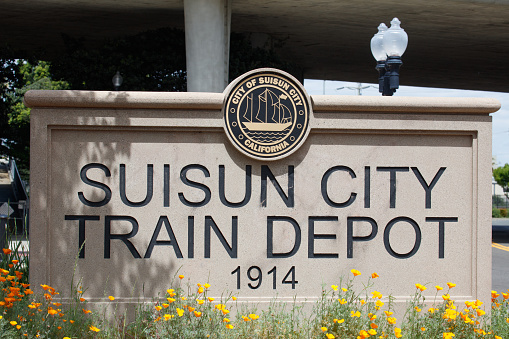 Suisun City, California / USA - April 24 2024: An image of the Suisun City Train Depot sign located in front of the Suisun City Amtrak station.
