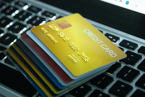 Several credit cards placed on a notebook computer keyboard To pay and pay for goods through credit cards, finance and banking.